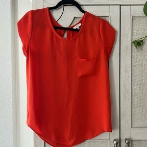 Beautiful orangey, red silk blouse